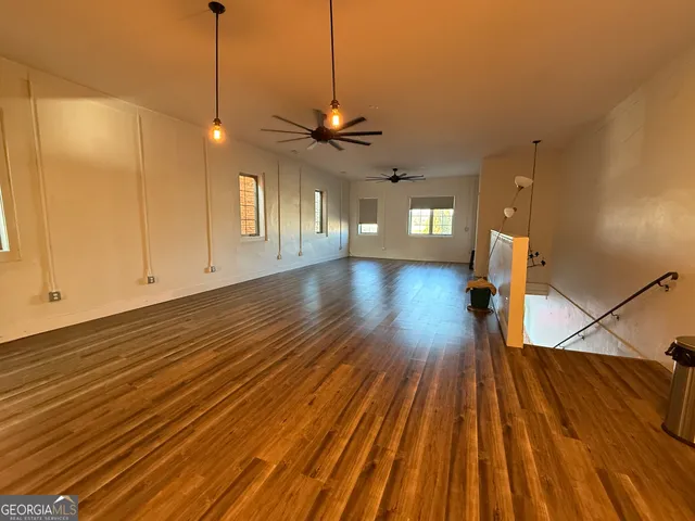a view of a room with wooden floor