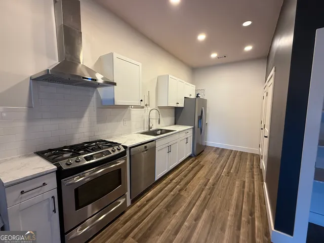 a large kitchen with a stove and a sink