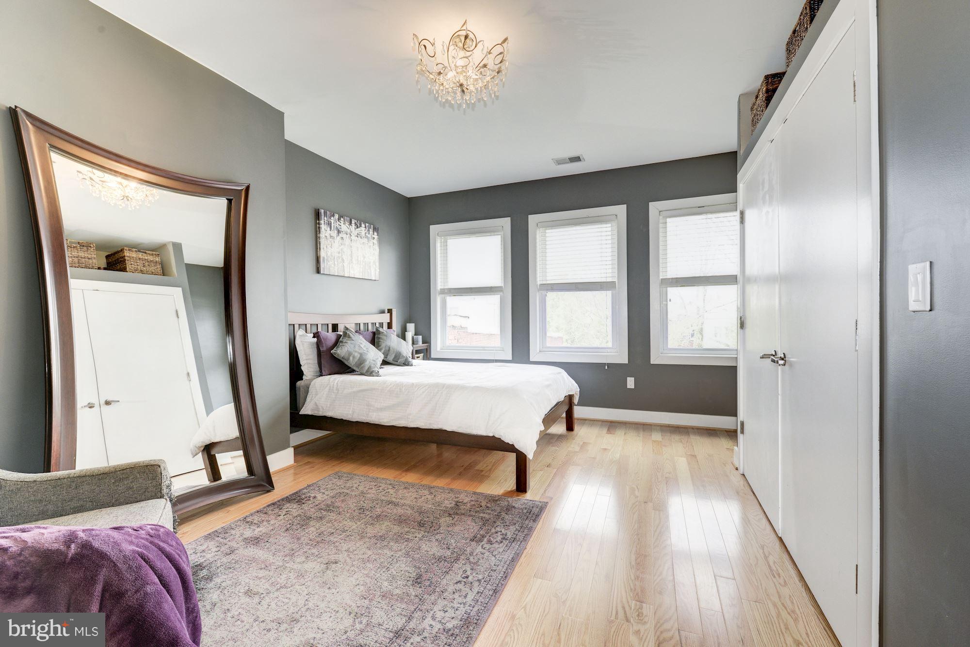 1309 Park Road Northwest, Unit 301 Washington, DC 20010 - Photo 9 of 23 Light-filled master bedroom with hardwood floors