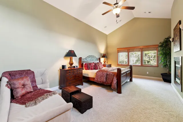 a bathroom with a granite countertop sink a toilet and a large mirror