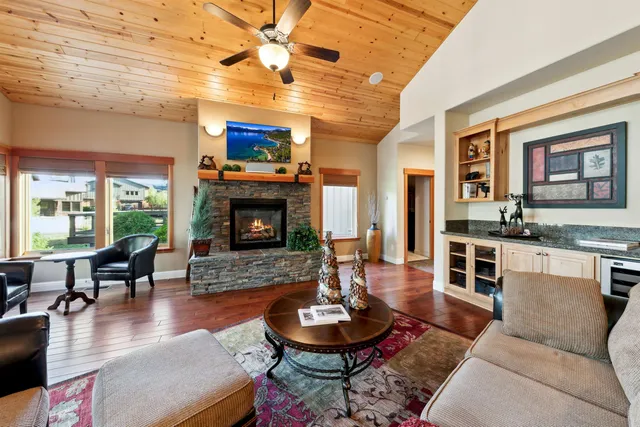 a living room with furniture kitchen view and a chandelier