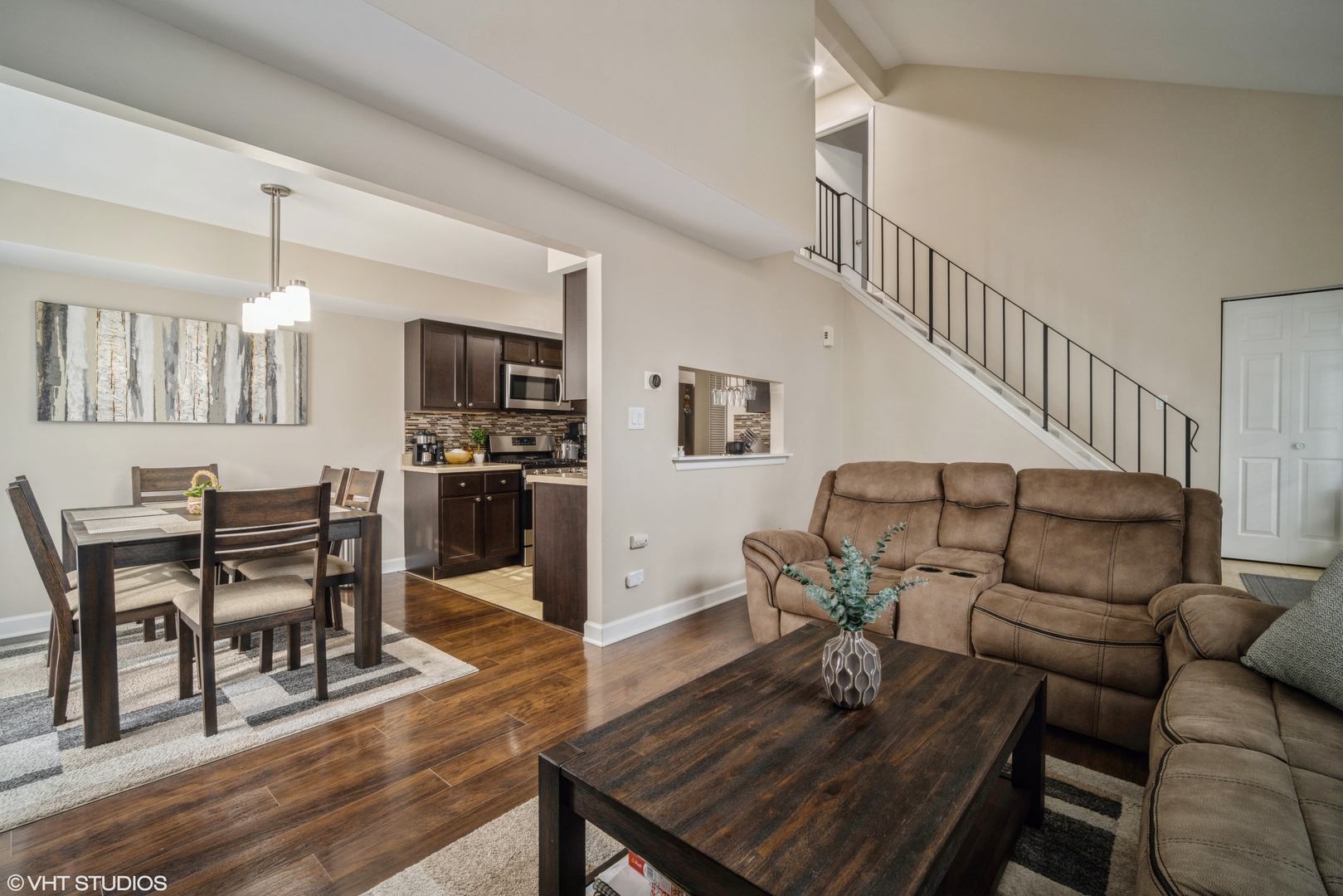 223 Butternut Lane Streamwood, IL 60107 - Photo 3 of 11 a view of a dining room with furniture a kitchen and chandelier