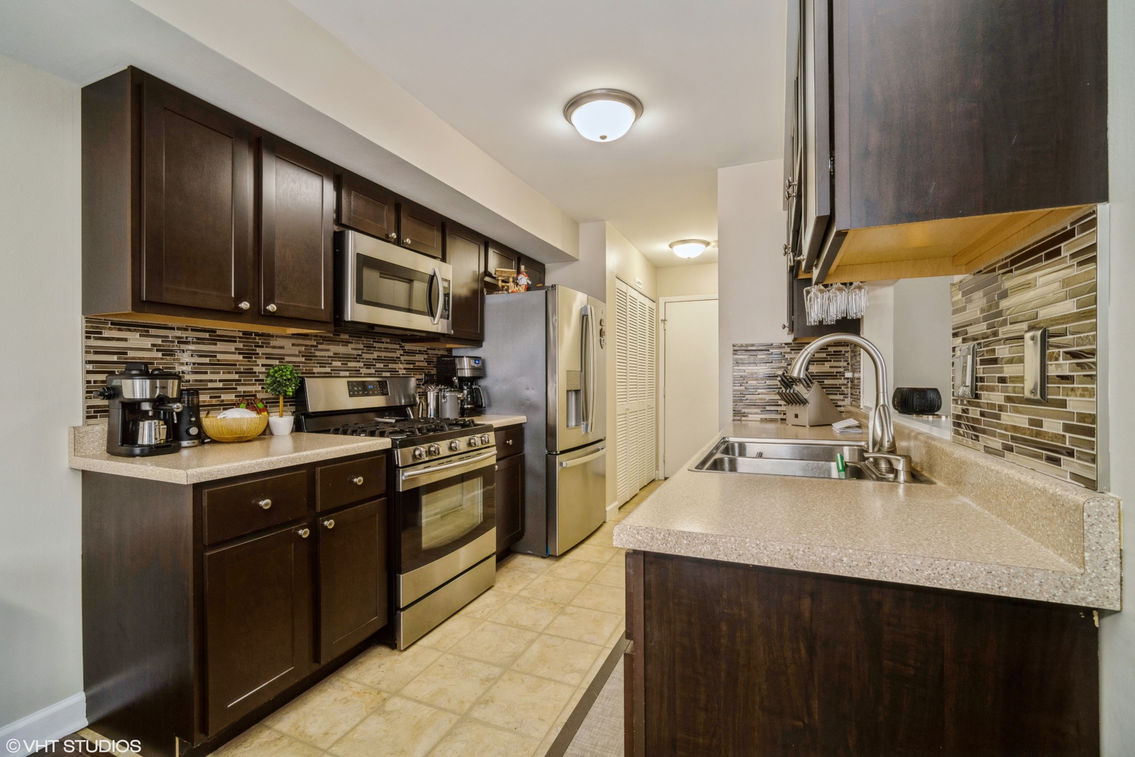 223 Butternut Lane Streamwood, IL 60107 - Photo 5 of 11 a kitchen with stainless steel appliances granite countertop a sink stove and refrigerator