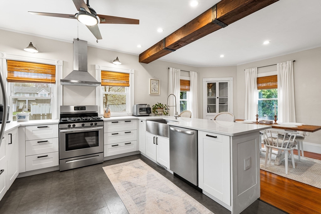 11 Draper Road Framingham, MA 01702 - Photo 6 of 23 a kitchen with stainless steel appliances white cabinets and wooden floors