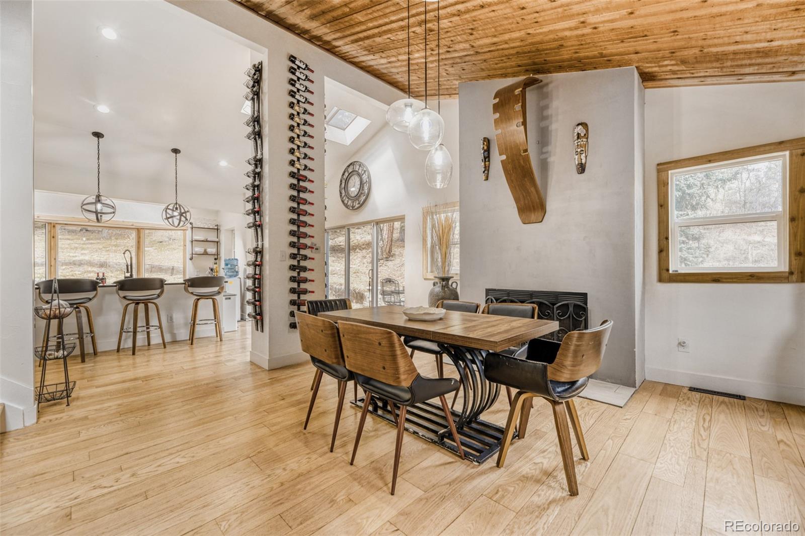 7489 South Turkey Creek Road Morrison, CO 80465 - Photo 10 of 28 a view of a dining room with furniture and wooden floor