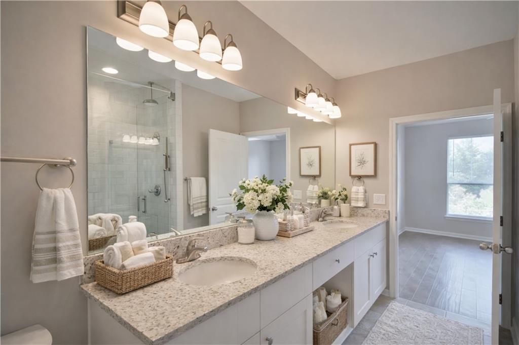 10 Perimeter Summit Boulevard, Unit 4139 Atlanta, GA 30319 - Photo 4 of 15 a bathroom with a granite countertop double vanity and a mirror