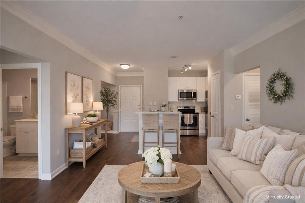 10 Perimeter Summit Boulevard, Unit 4139 Atlanta, GA 30319 - Photo 6 of 15 a living room with furniture kitchen view and a wooden floor