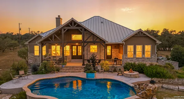 a view of a house with swimming pool and sitting area