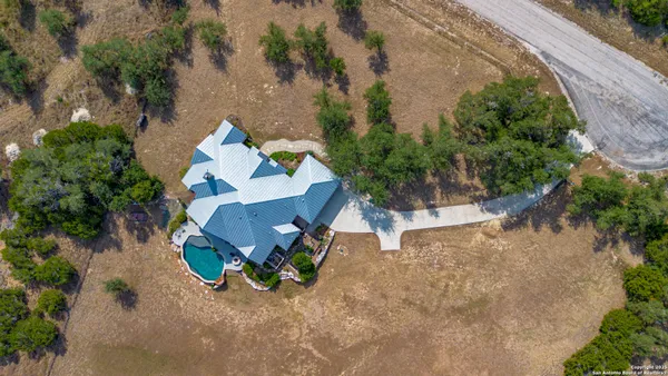 an aerial view of a house with outdoor space and sitting area