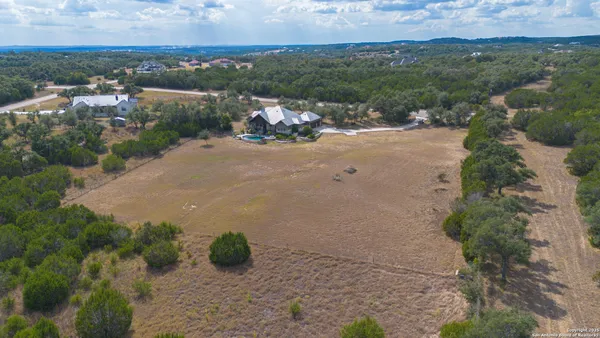 an aerial view of a house with yard