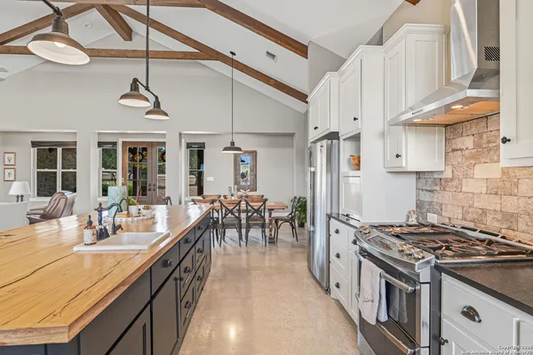 a kitchen with stove and cabinets