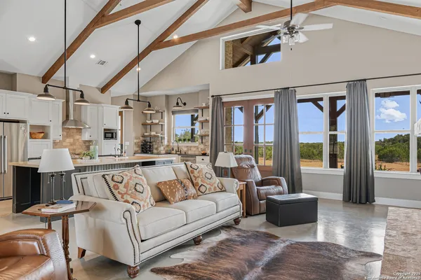 a view of a livingroom with furniture wooden floor and a rug