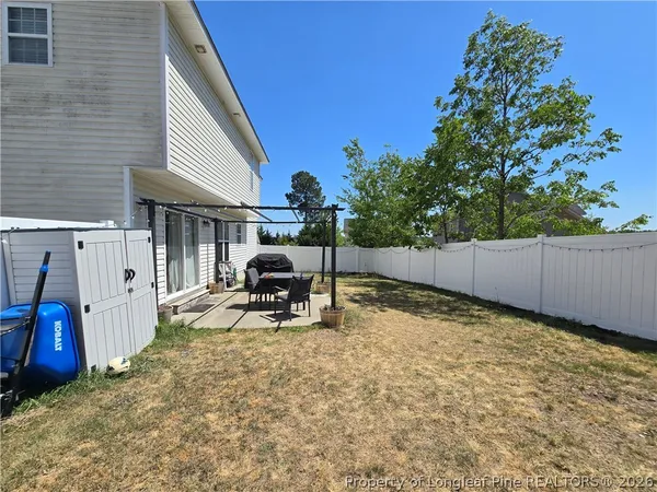 a view of a backyard with a table and chairs