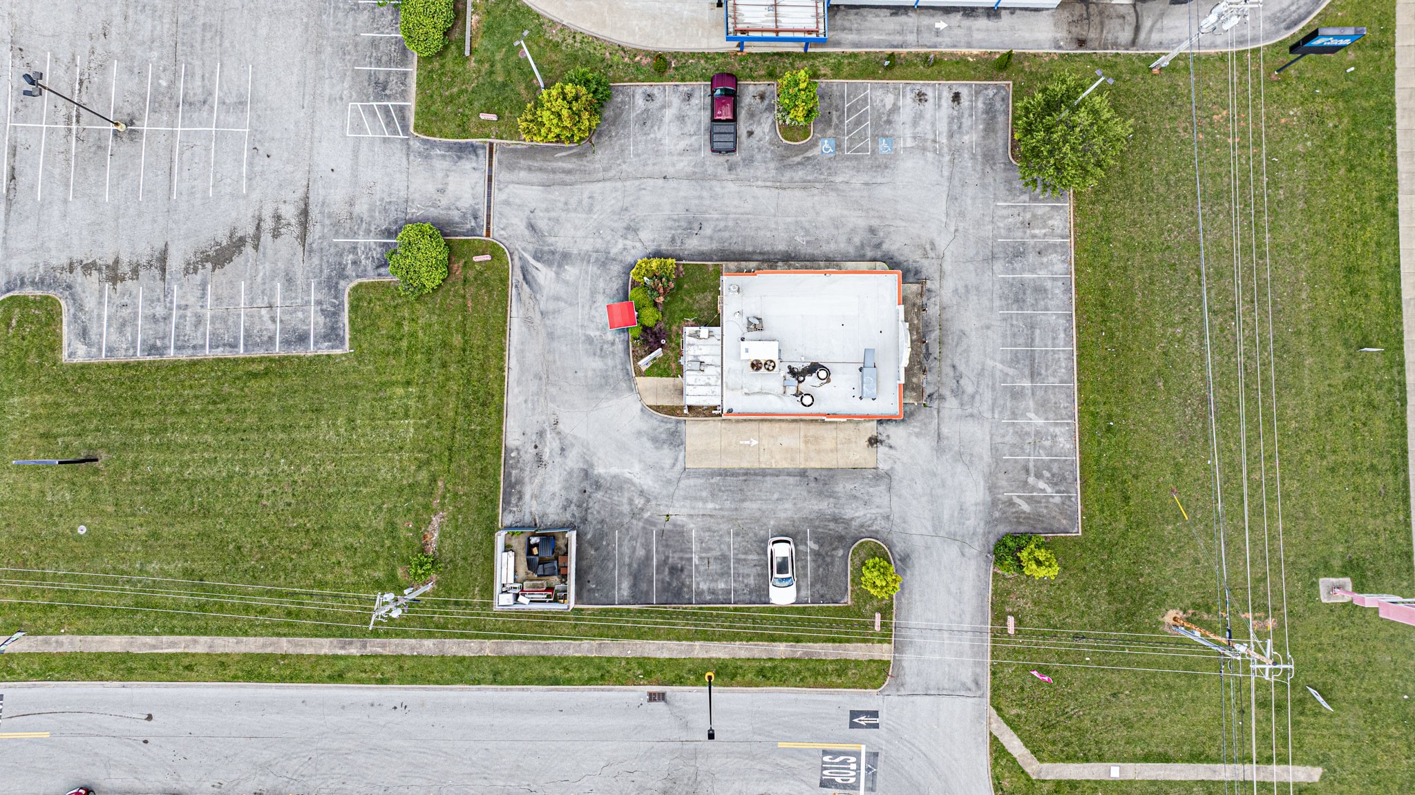 1442 Nashville Road Franklin, KY 42134 - Photo 11 of 20 a view of a brick wall with a small yard and a wooden fence