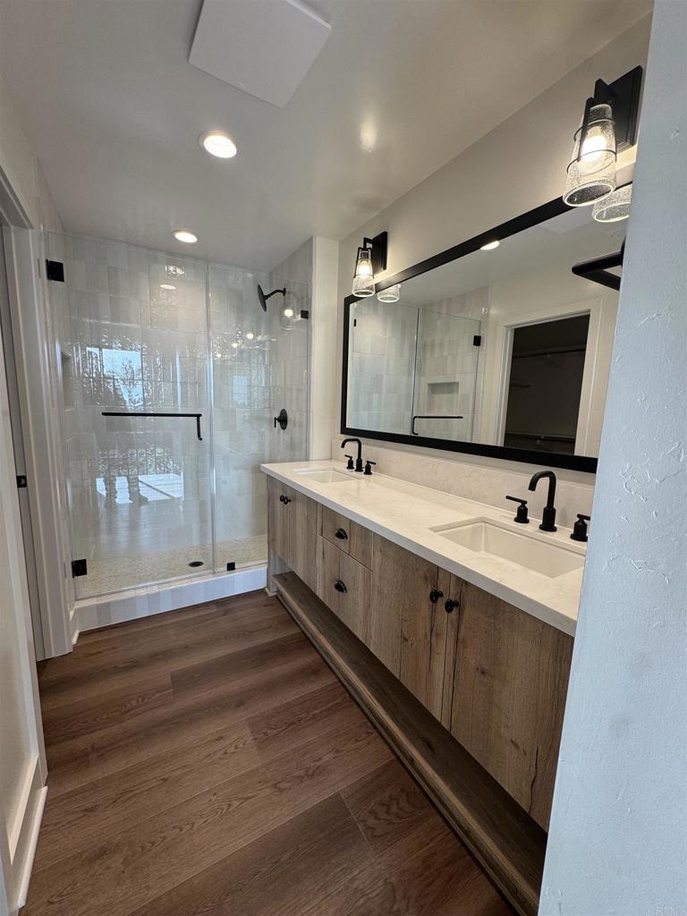 1105 Catania Court, Unit 201 Encinitas, CA 92024 - Photo 15 of 19 a spacious bathroom with double vanity and mirrors