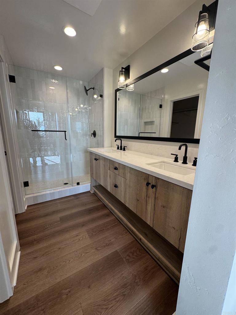 1105 Catania Court, Unit 201 Encinitas, CA 92024 - Photo 9 of 19 a bathroom with a double vanity sink mirror and shower