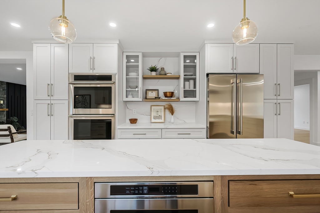 54 Spywood Road Sherborn, MA 01770 - Photo 12 of 42 a kitchen with kitchen island a counter space stainless steel appliances and cabinets