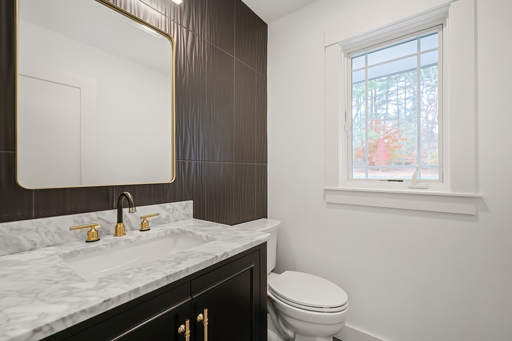 54 Spywood Road Sherborn, MA 01770 - Photo 20 of 42 a bathroom with a granite countertop sink a toilet and a mirror