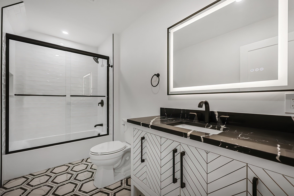 54 Spywood Road Sherborn, MA 01770 - Photo 30 of 42 a bathroom with a granite countertop sink mirror vanity and toilet