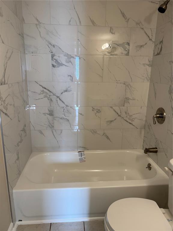 5521 Bay Boulevard, Unit 105 Port Richey, FL 34668 - Photo 10 of 15 a bathroom with a bathtub and a toilet