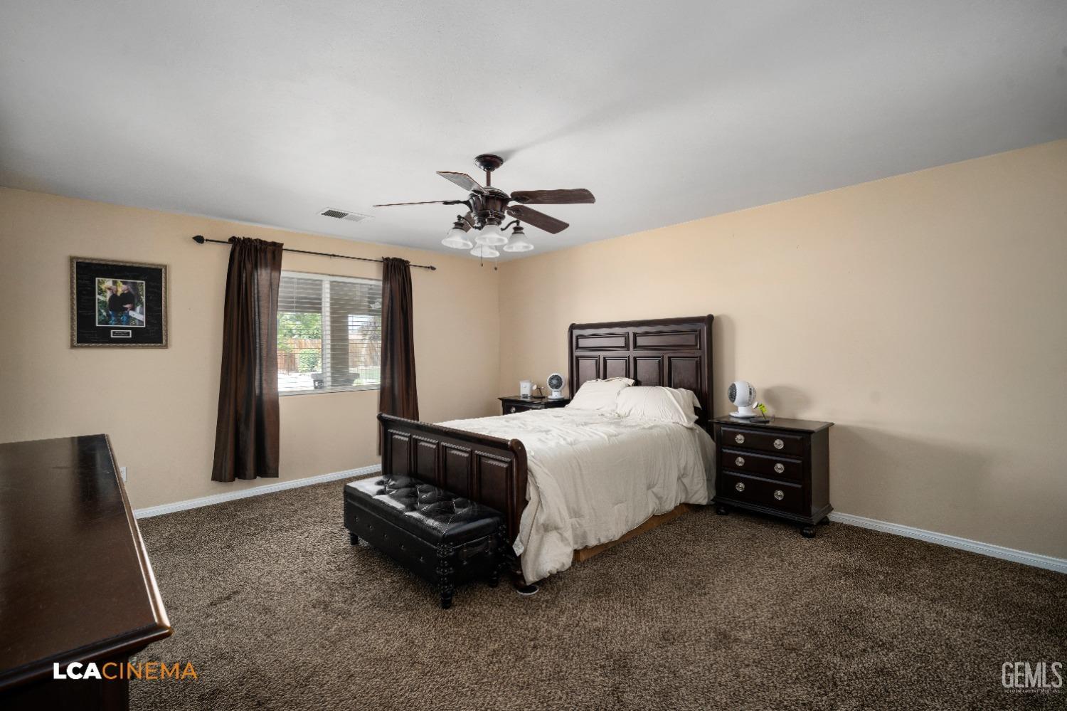 Undisclosed Address Bakersfield, CA 93312 - Photo 17 of 38 a bedroom with a bed and a chandelier