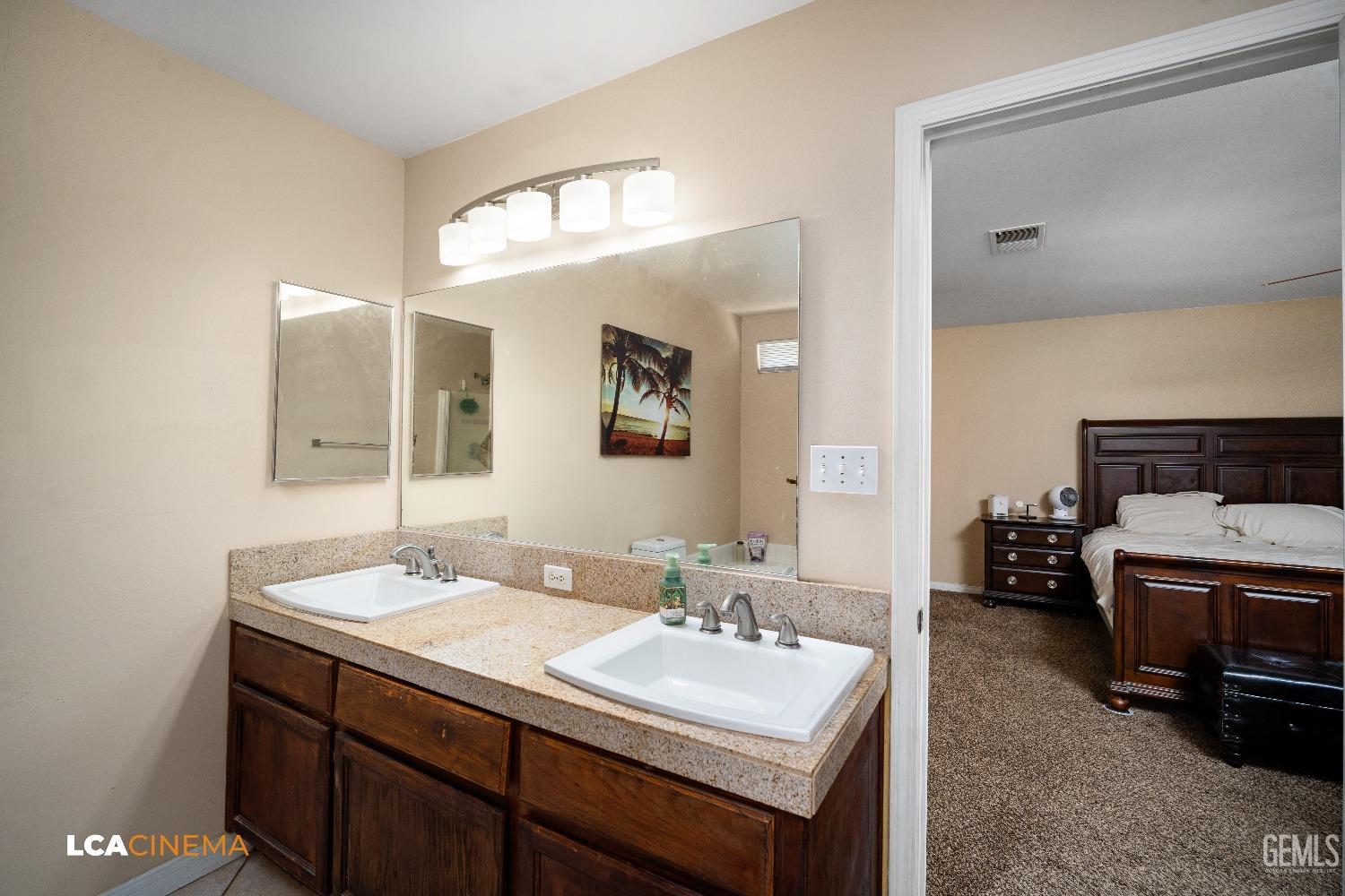 Undisclosed Address Bakersfield, CA 93312 - Photo 20 of 38 a bathroom with a sink double vanity and a mirror
