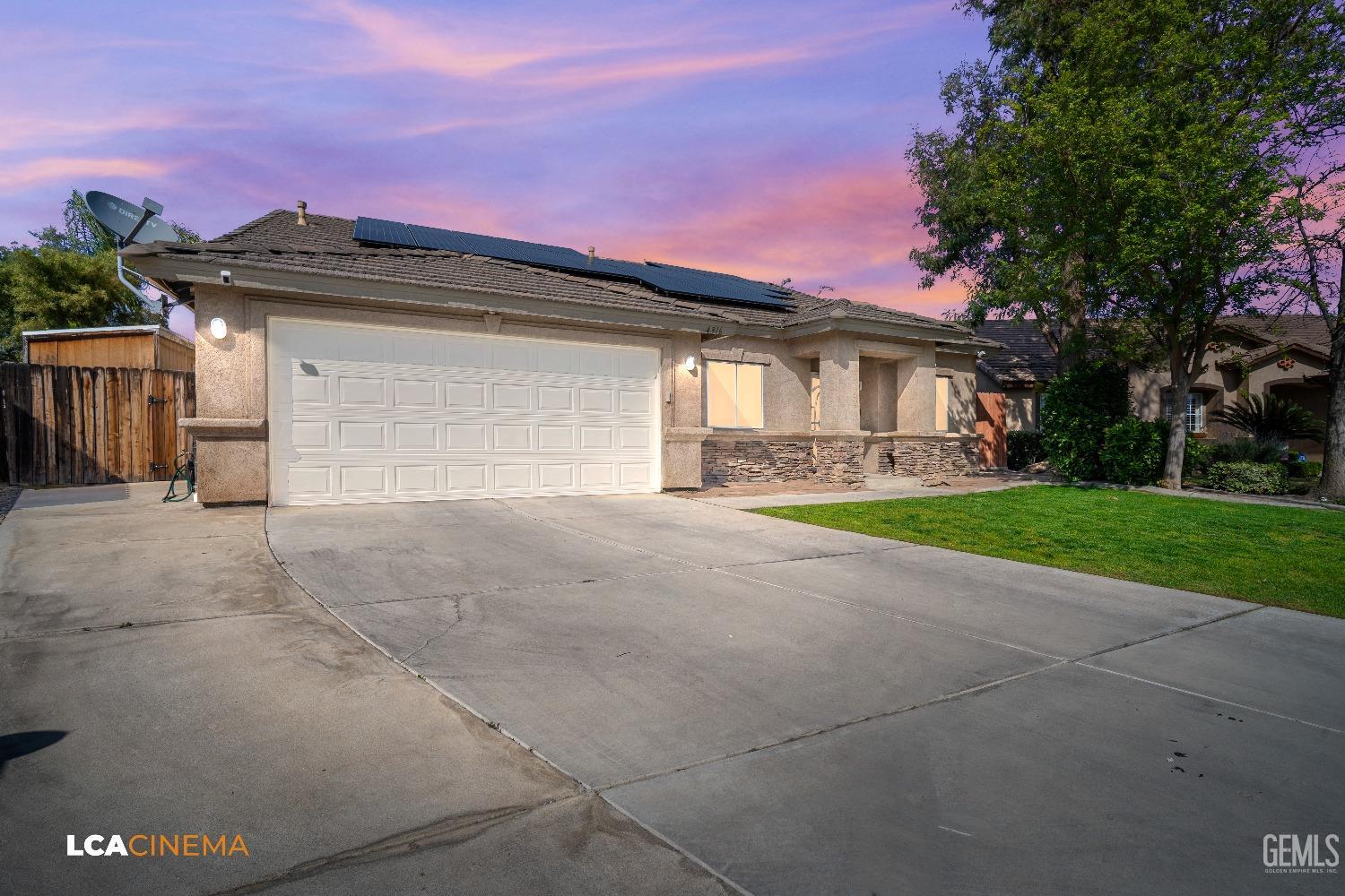 Undisclosed Address Bakersfield, CA 93312 - Photo 2 of 38 a front view of a house with a yard and garage
