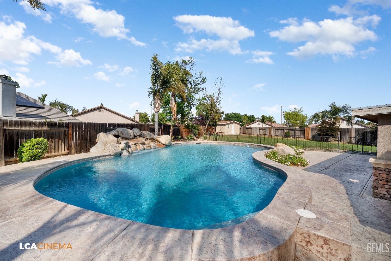 Undisclosed Address Bakersfield, CA 93312 - Photo 24 of 38 a view of a swimming pool with a yard