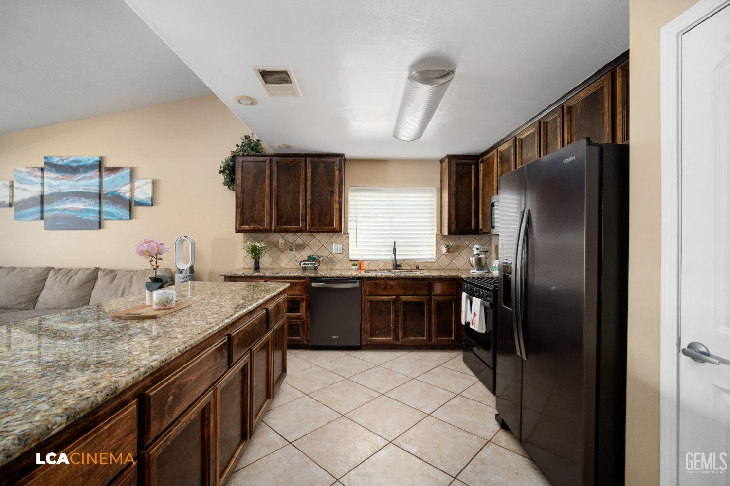 Undisclosed Address Bakersfield, CA 93312 - Photo 7 of 38 a kitchen with granite countertop stainless steel appliances a refrigerator sink and cabinets