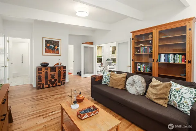 a living room with furniture and a book shelf