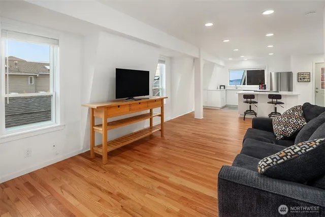 a kitchen with stainless steel appliances granite countertop wooden floors and sink
