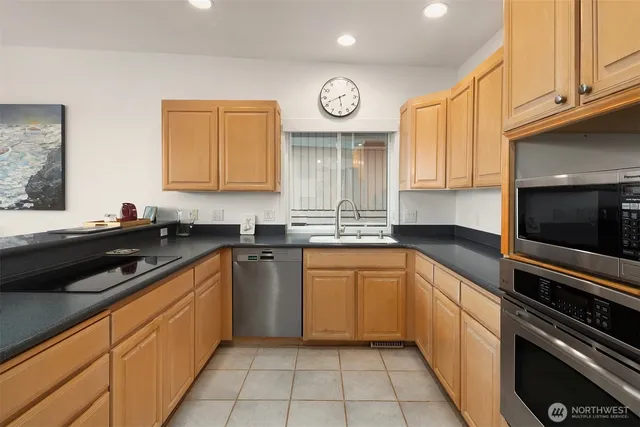 a kitchen with a sink cabinets and stainless steel appliances
