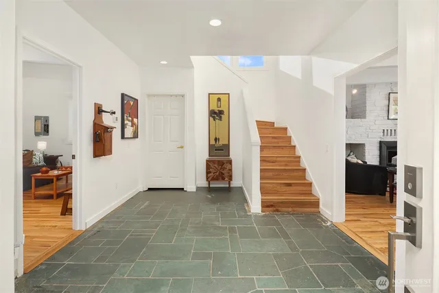 a view of a hallway with stairs and furniture