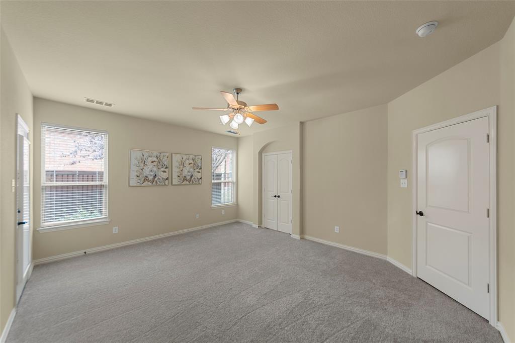 5143 Stream Crest Way Fairview, TX 75069 - Photo 16 of 35 Empty room featuring a ceiling fan, light carpet, and arched walkways