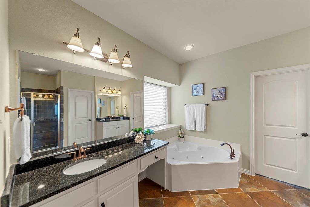 5143 Stream Crest Way Fairview, TX 75069 - Photo 17 of 35 Bathroom with vanity, a jetted tub, and a stall shower