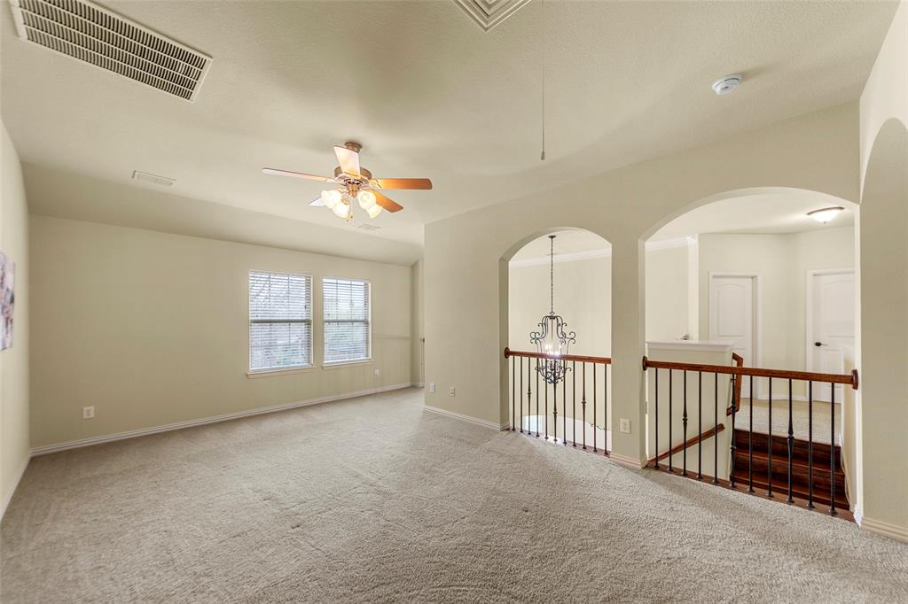 5143 Stream Crest Way Fairview, TX 75069 - Photo 23 of 35 Empty room with ceiling fan, carpet, and a chandelier