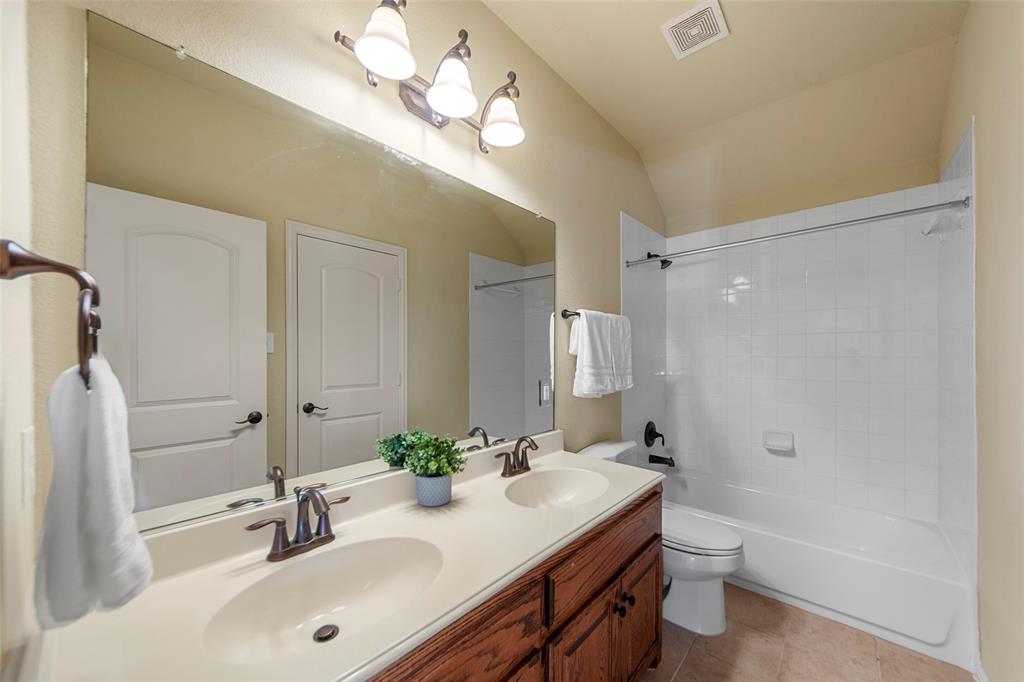 5143 Stream Crest Way Fairview, TX 75069 - Photo 26 of 35 Full bathroom featuring double vanity, bathing tub / shower combination, light tile patterned flooring, and vaulted ceiling