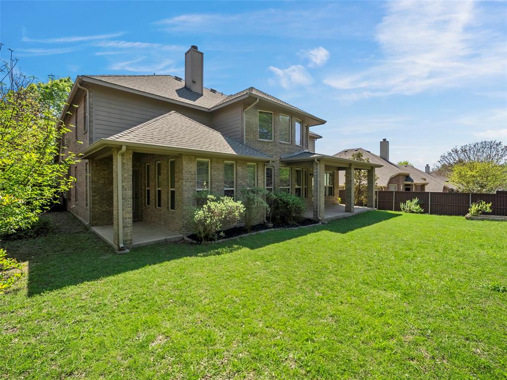 5143 Stream Crest Way Fairview, TX 75069 - Photo 30 of 35 Rear view of house featuring a patio, brick siding, a chimney, and a shingled roof