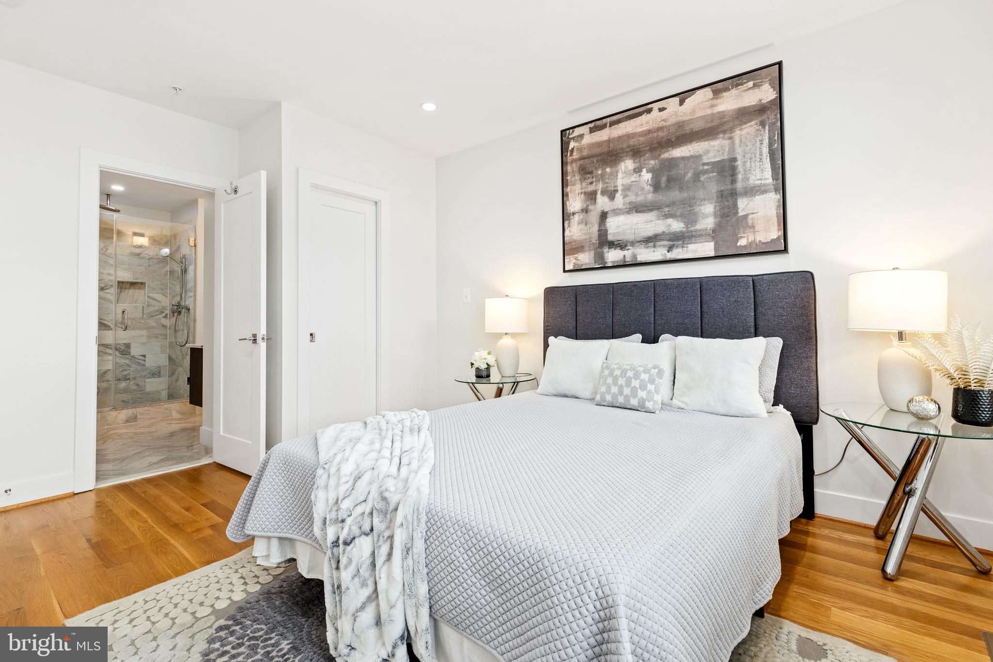 1337 Spring Road Northwest, Unit 1 Washington, DC 20010 - Photo 16 of 39 a bedroom with a bed and wooden floor