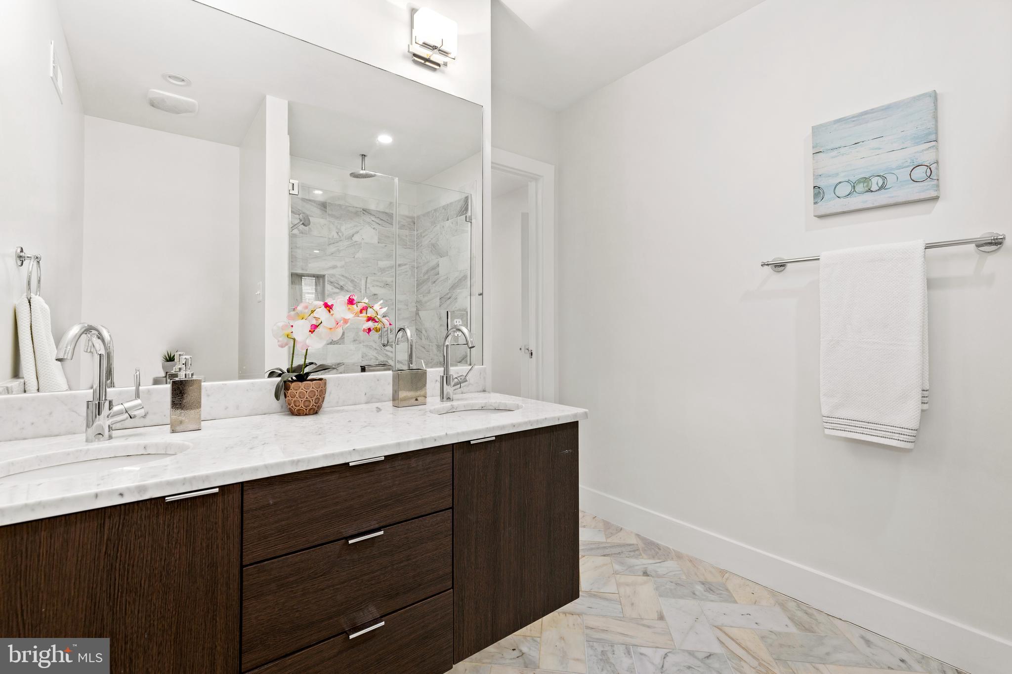 1337 Spring Road Northwest, Unit 1 Washington, DC 20010 - Photo 19 of 39 a bathroom with a granite countertop sink mirror and double
