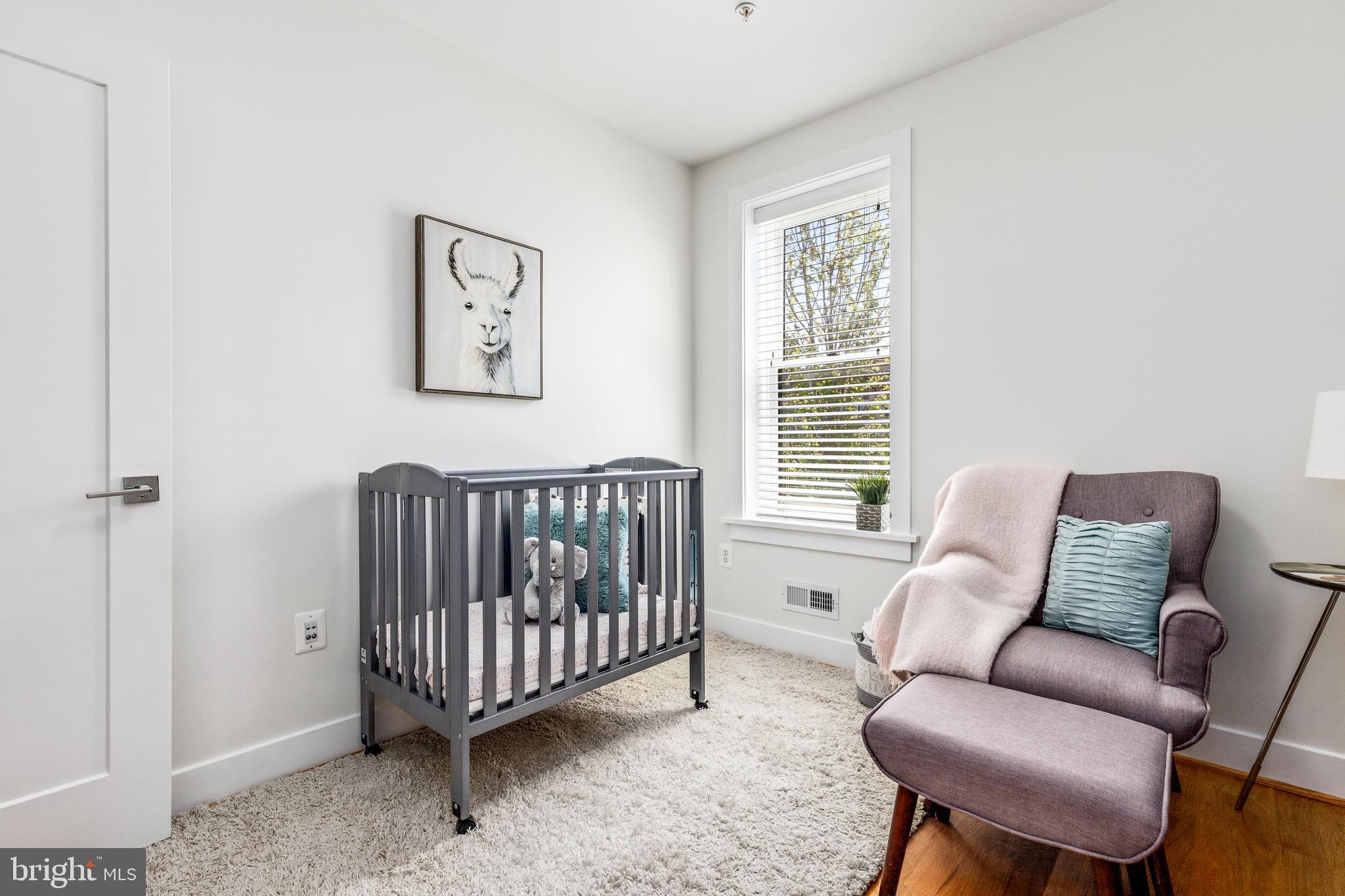 1337 Spring Road Northwest, Unit 1 Washington, DC 20010 - Photo 22 of 39 a living room with furniture a couch and a window