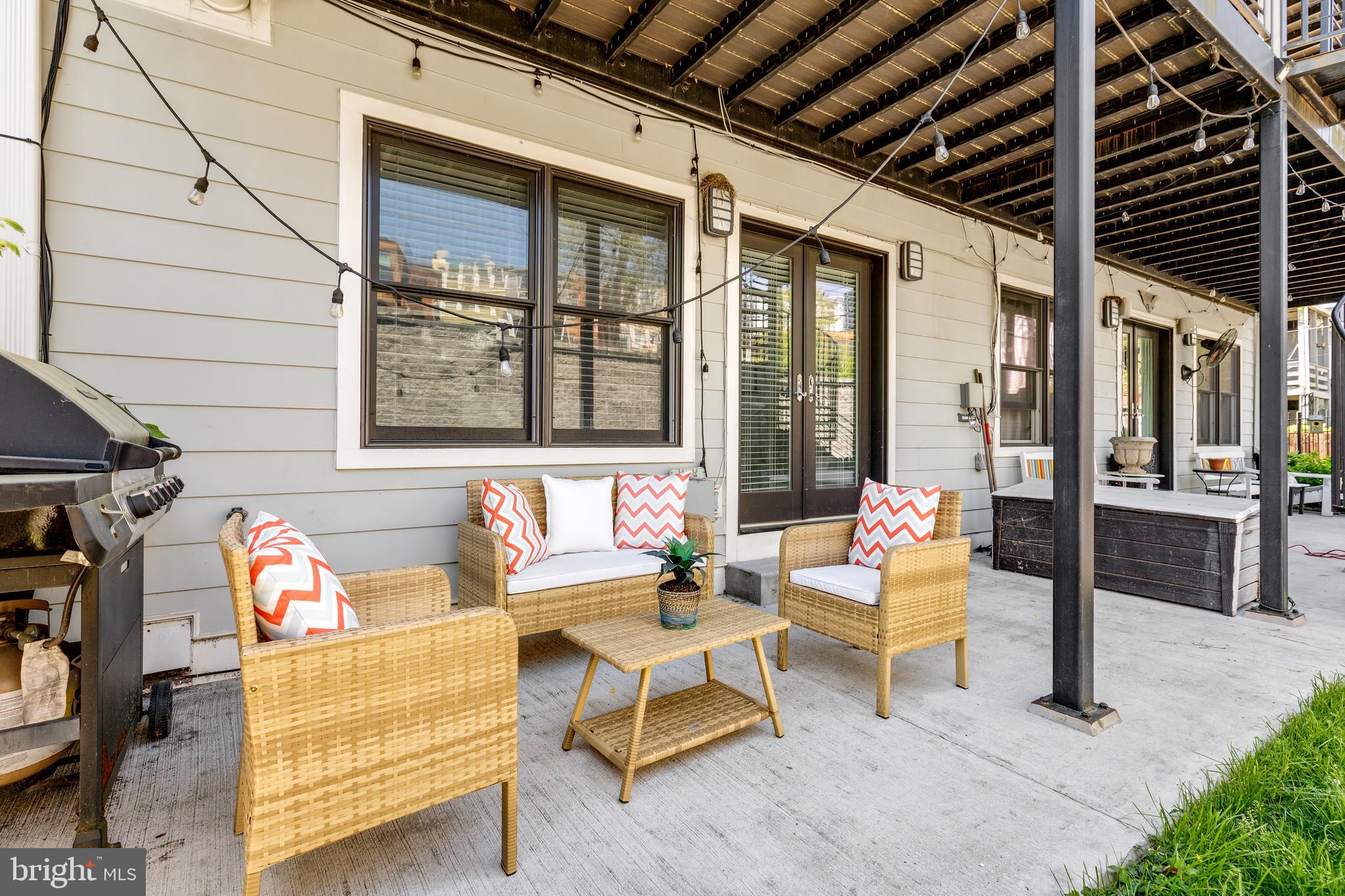 1337 Spring Road Northwest, Unit 1 Washington, DC 20010 - Photo 34 of 39 a outdoor living space with patio furniture and a window