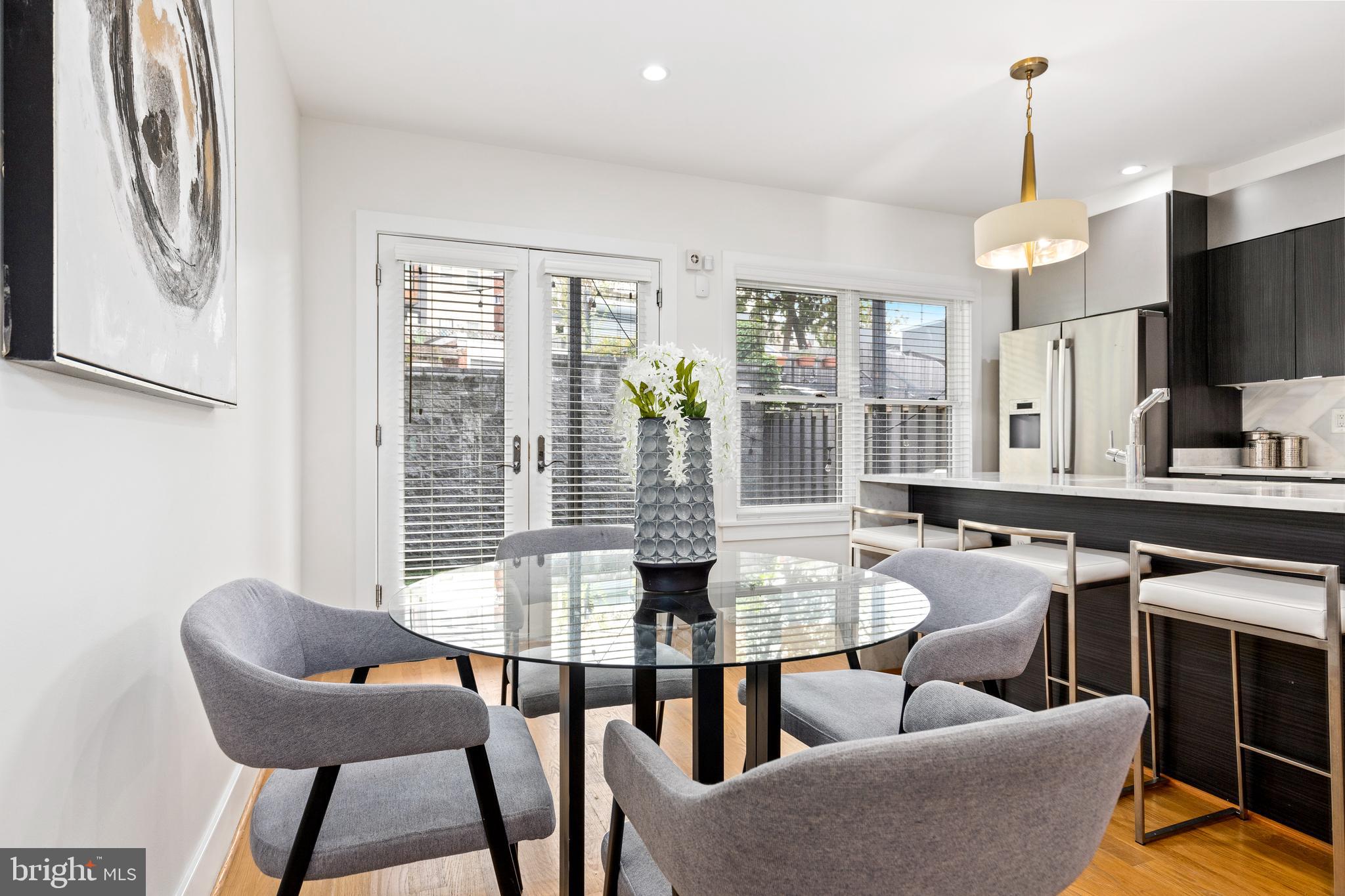 1337 Spring Road Northwest, Unit 1 Washington, DC 20010 - Photo 6 of 39 a view of a dining room with furniture window and outside view
