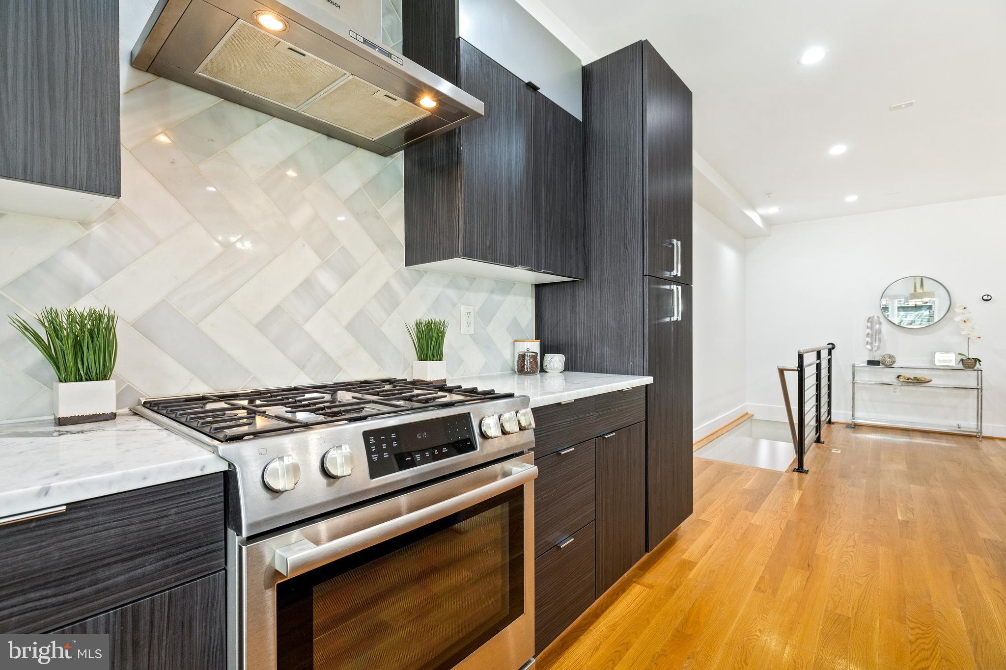 1337 Spring Road Northwest, Unit 1 Washington, DC 20010 - Photo 10 of 39 a kitchen with a stove and a wooden floors
