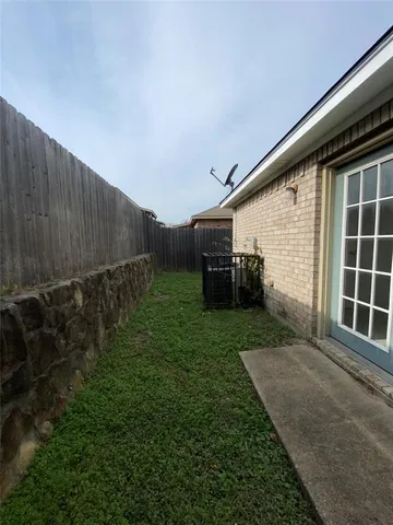 a backyard of a house with lots of green space and plants