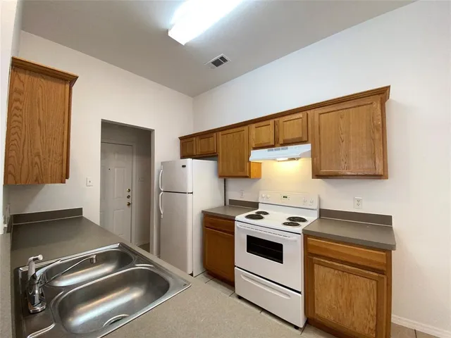 a kitchen with a stove microwave and refrigerator