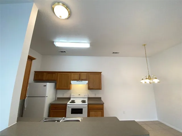 a room with a fireplace and a chandelier