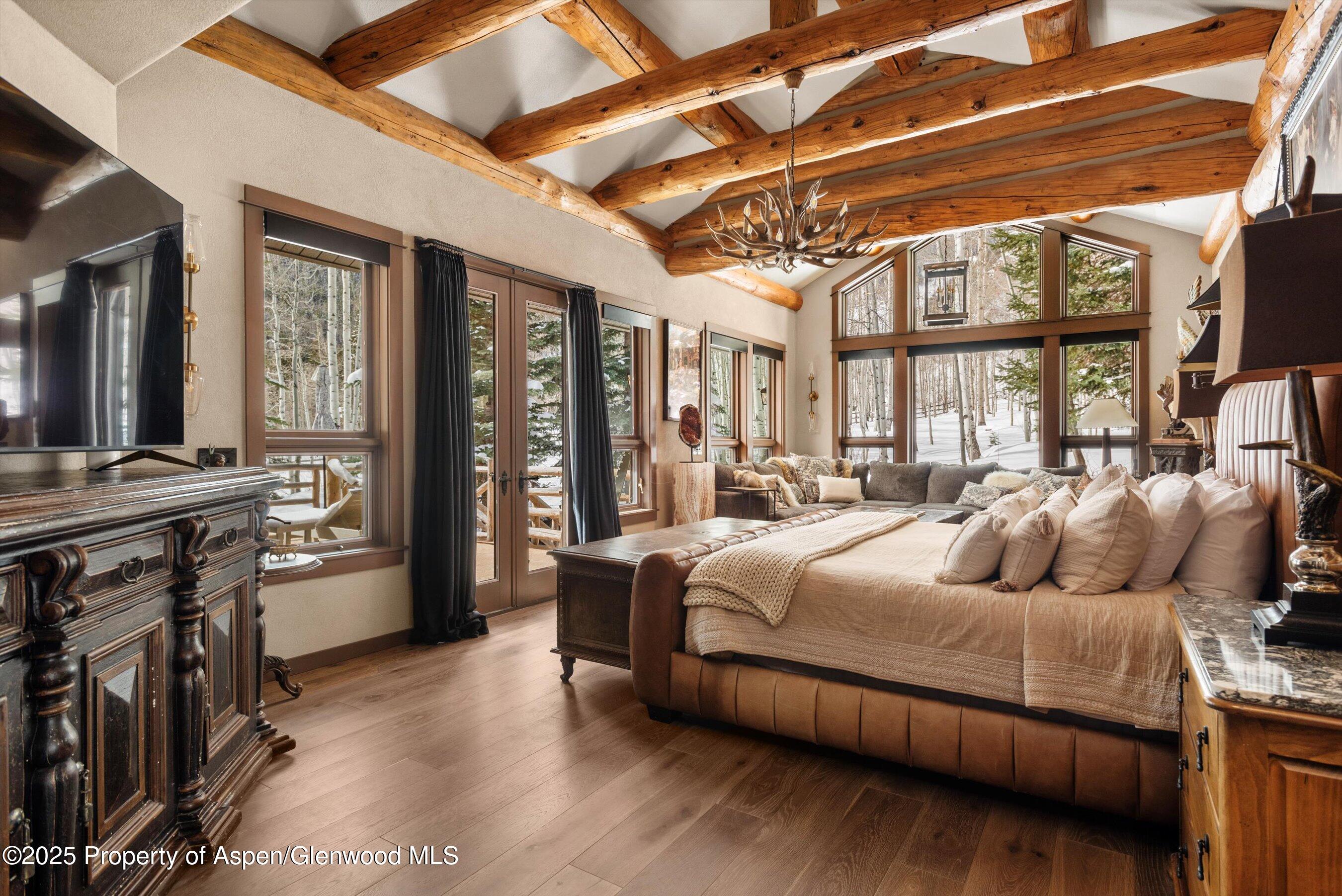 303 Conundrum Creek Road Aspen, CO 81611 - Photo 11 of 39 a bedroom with a large bed and a balcony