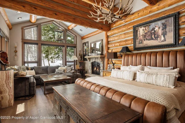 a bedroom with a bed couch and a window