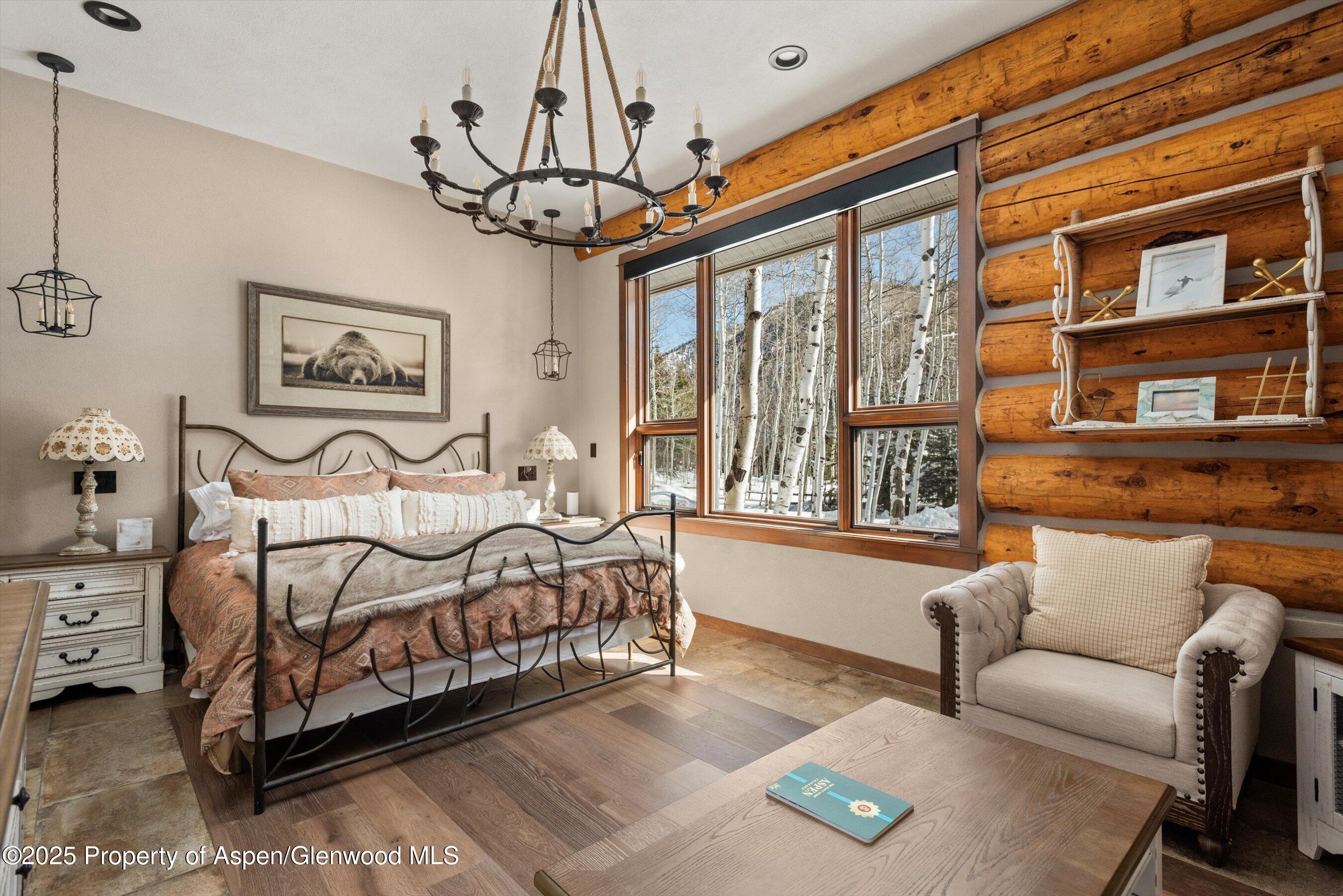 303 Conundrum Creek Road Aspen, CO 81611 - Photo 18 of 39 a bedroom with a bed couch and a window